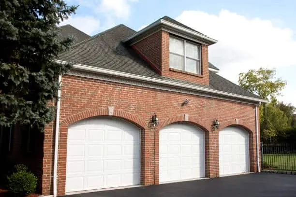 Garage doors of red brick home.