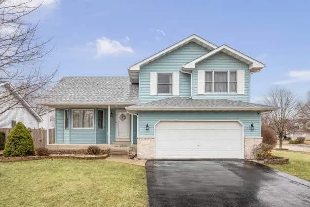 Exterior of a suburban home with a light blue siding and white shutters.