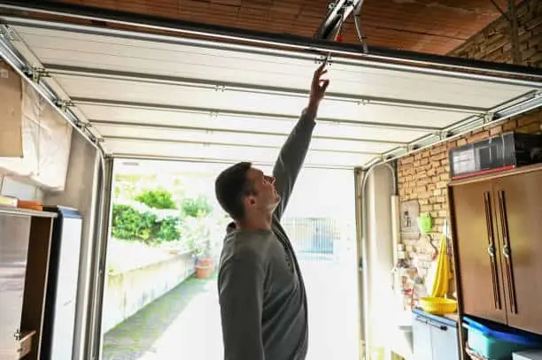 Man reaching for garage door opener