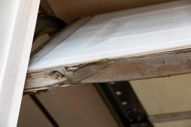 Worn out weather stripping on a garage door.