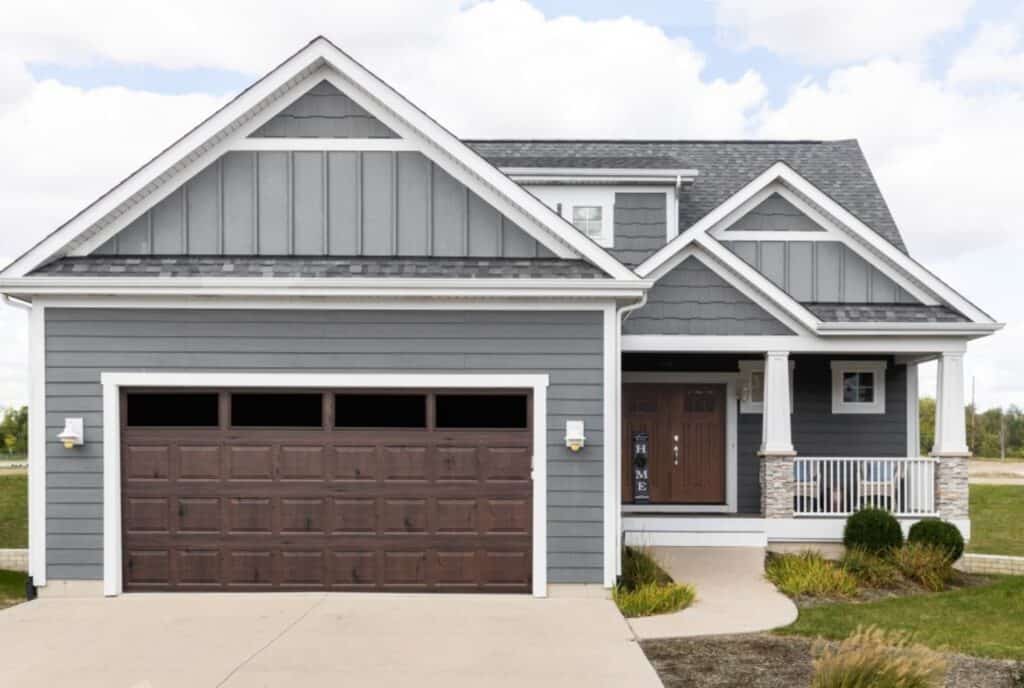 Gray house with brown woodgrain garage door - Chelsea Garage Door Repair, Service, & Maintenance