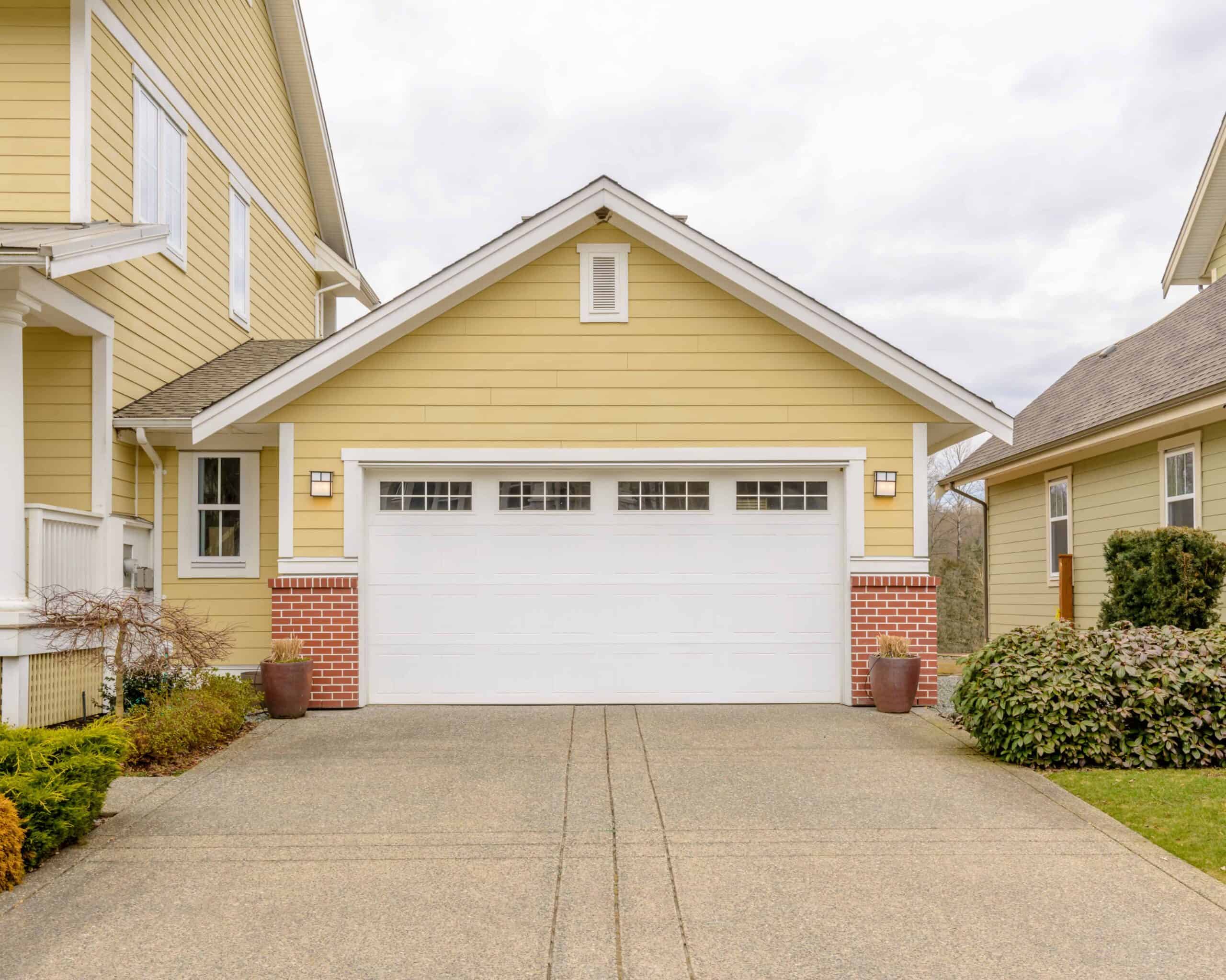 Yellow house with white garage door