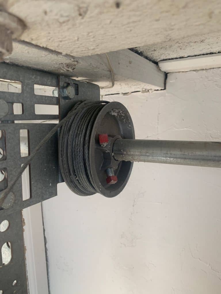 Loose garage cable wires inside a cable drum. 