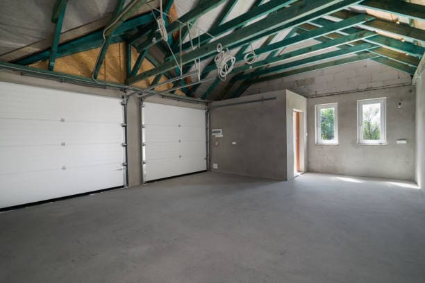 Unfinished two car garage interior. Hell Garage Door Repair.
