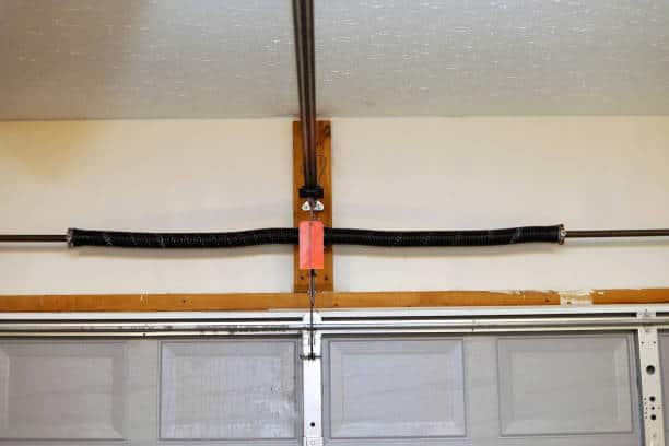 A close up image of a the springs on a overhead garage door opener - Fairgrove Garage Door Repair