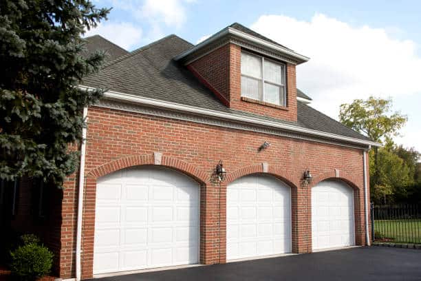 Garage doors of red brick home.