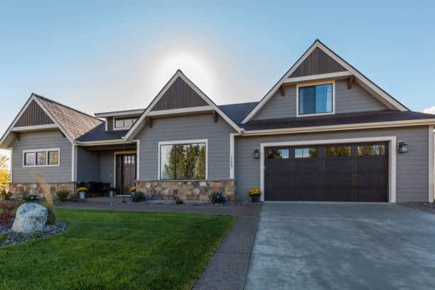 Grey house with a brown garage.