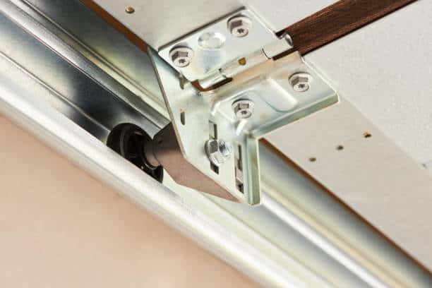 Automatic Garage Door mechanism close up. Lifting gates of the garage. Metal wheel, Springs tensioning, handle, fastening of a garage door.