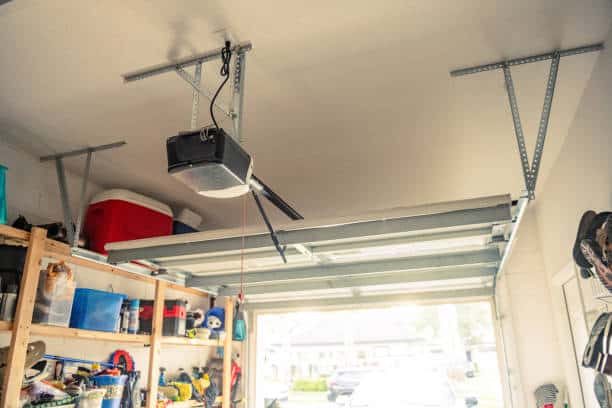 A photograph taken from looking out of an open one car garage door on a bright sunny day. Garden City Garage Door Repair