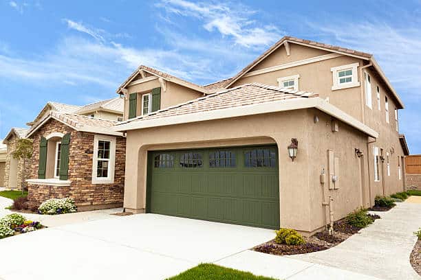 A modern suburb home with a green garage door.