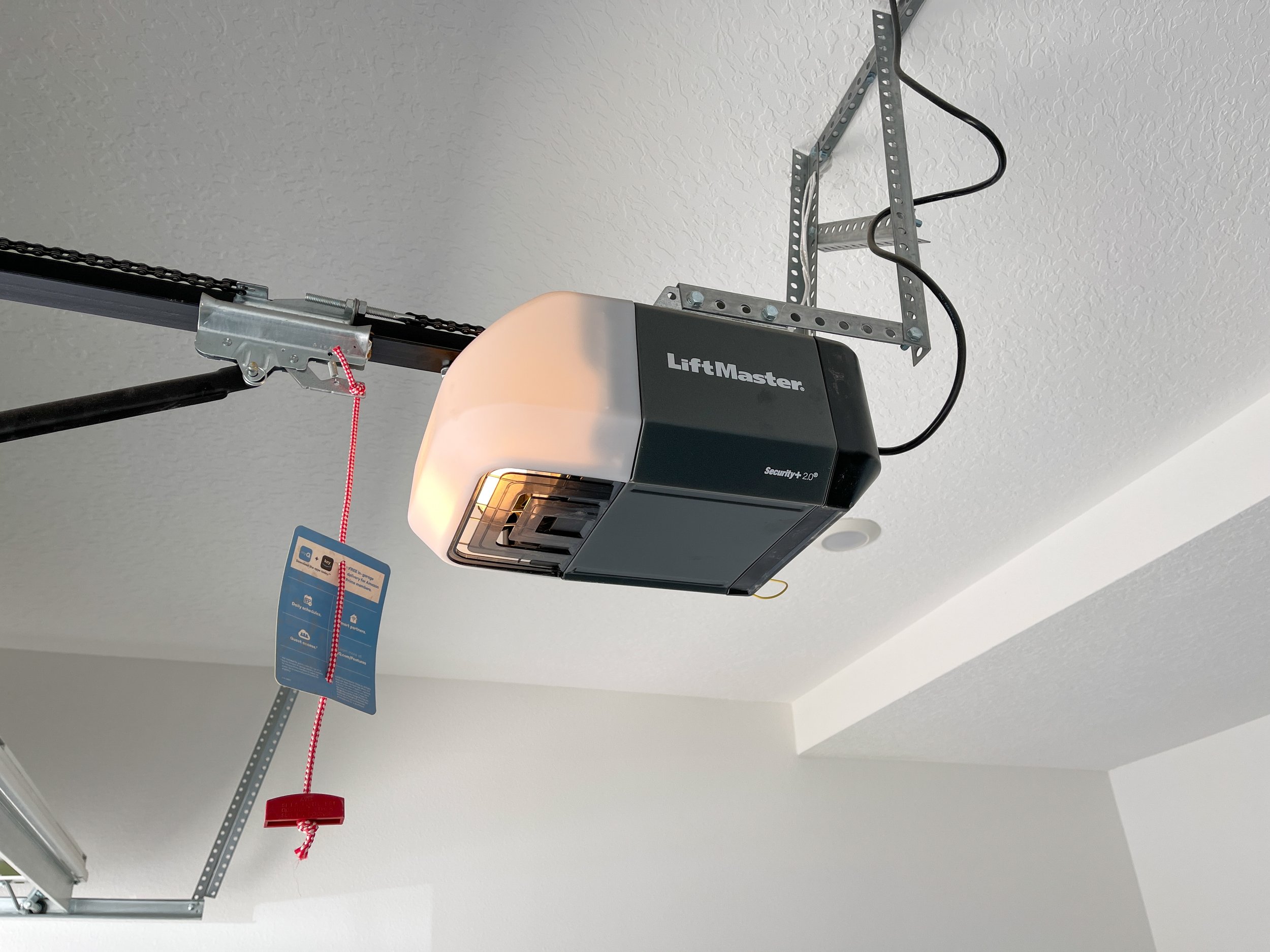 A LiftMaster garage door motor installed inside a garage.