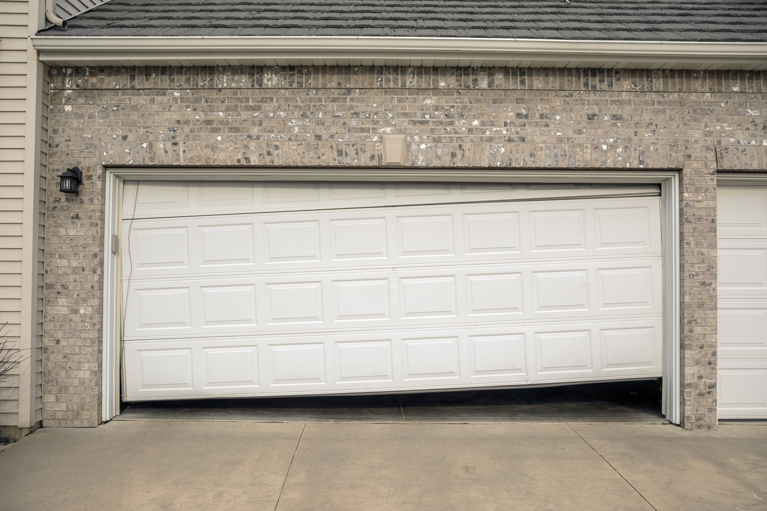 A garage door is damaged or broken.