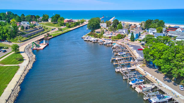 Aerial view above Pentwater river with dock, boats, and view of Lake Michigan