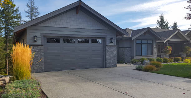 New modern home in a very lovely setting. Shingle and stone. Minimalism Landscaping. Two car garage.