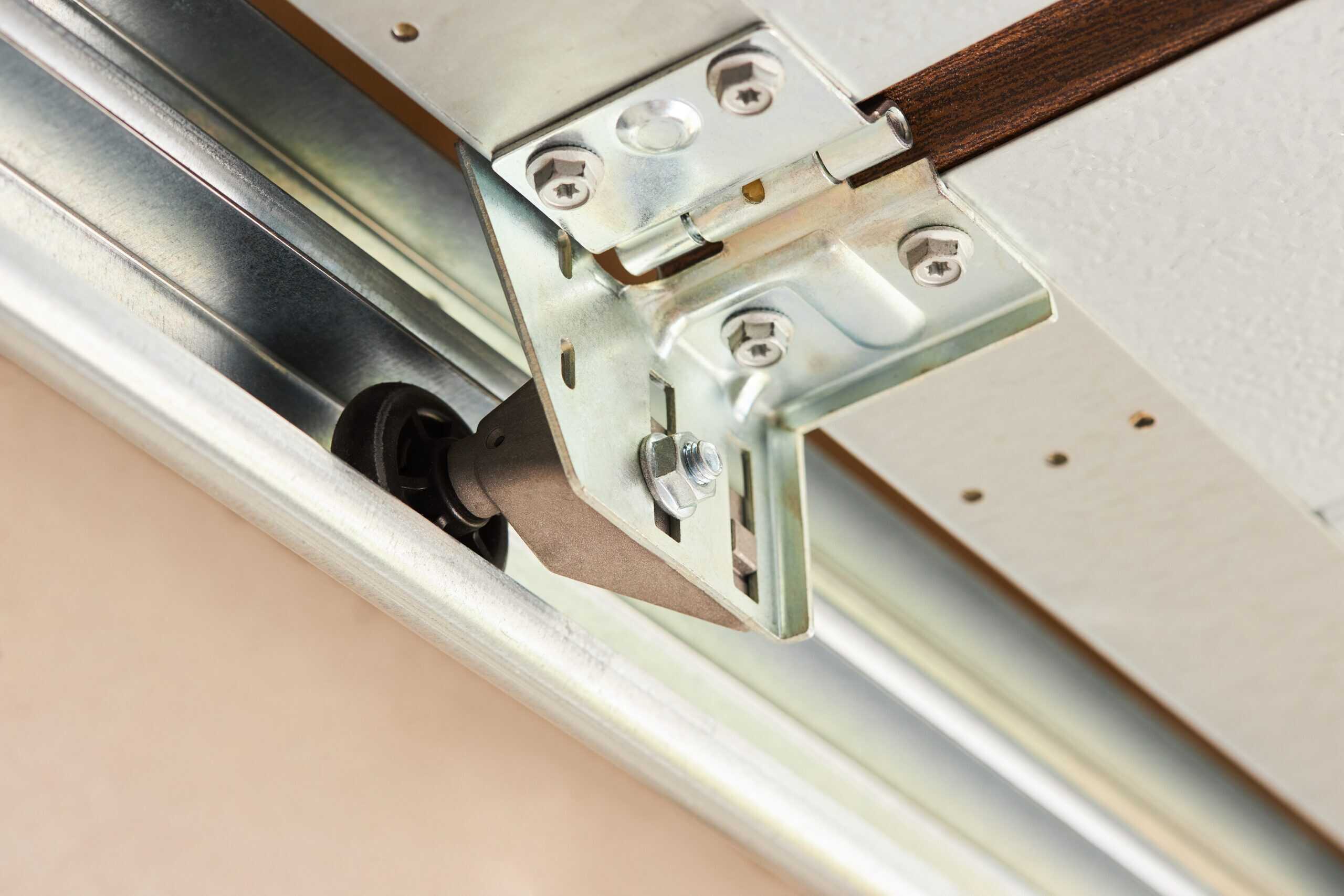 Rollers and Cables. Close up of garage door wheel in its track.