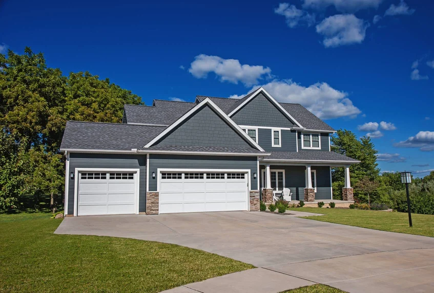 Beautiful modern blue home with recessed panel doors - Regular Garage Door Maintenance